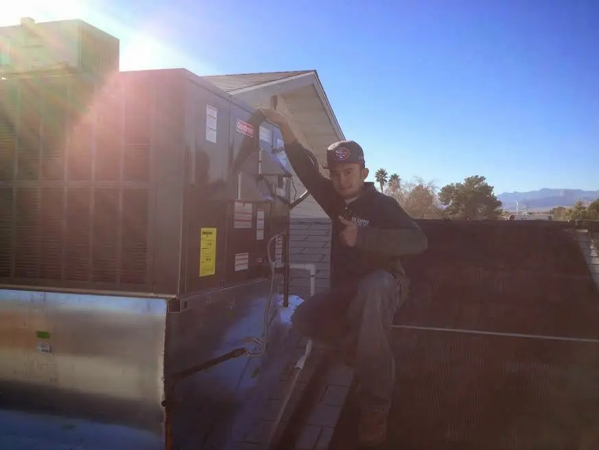 HVAC technician performing HVAC Inspection on a rooftop unit in Ashburn